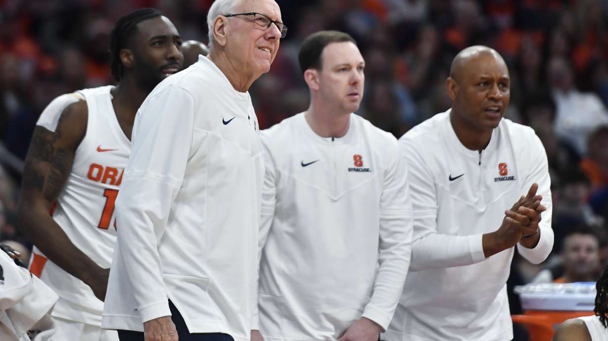 FILE -Syracuse head coach Jim Boeheim, left, assistant coach Gerry McNamara, center, and associate head coach Adrian Autry watch from the sideline during the second half of an NCAA college basketball game against Boston College in Syracuse, N.Y., Saturday, Dec. 31, 2022. Syracuse coach Jim Boeheim is retiring after 47 years of leading the university's basketball program, the team announced Wednesday, March 8, 2023 after a loss knocked them out of the ACC Conference Tournament.