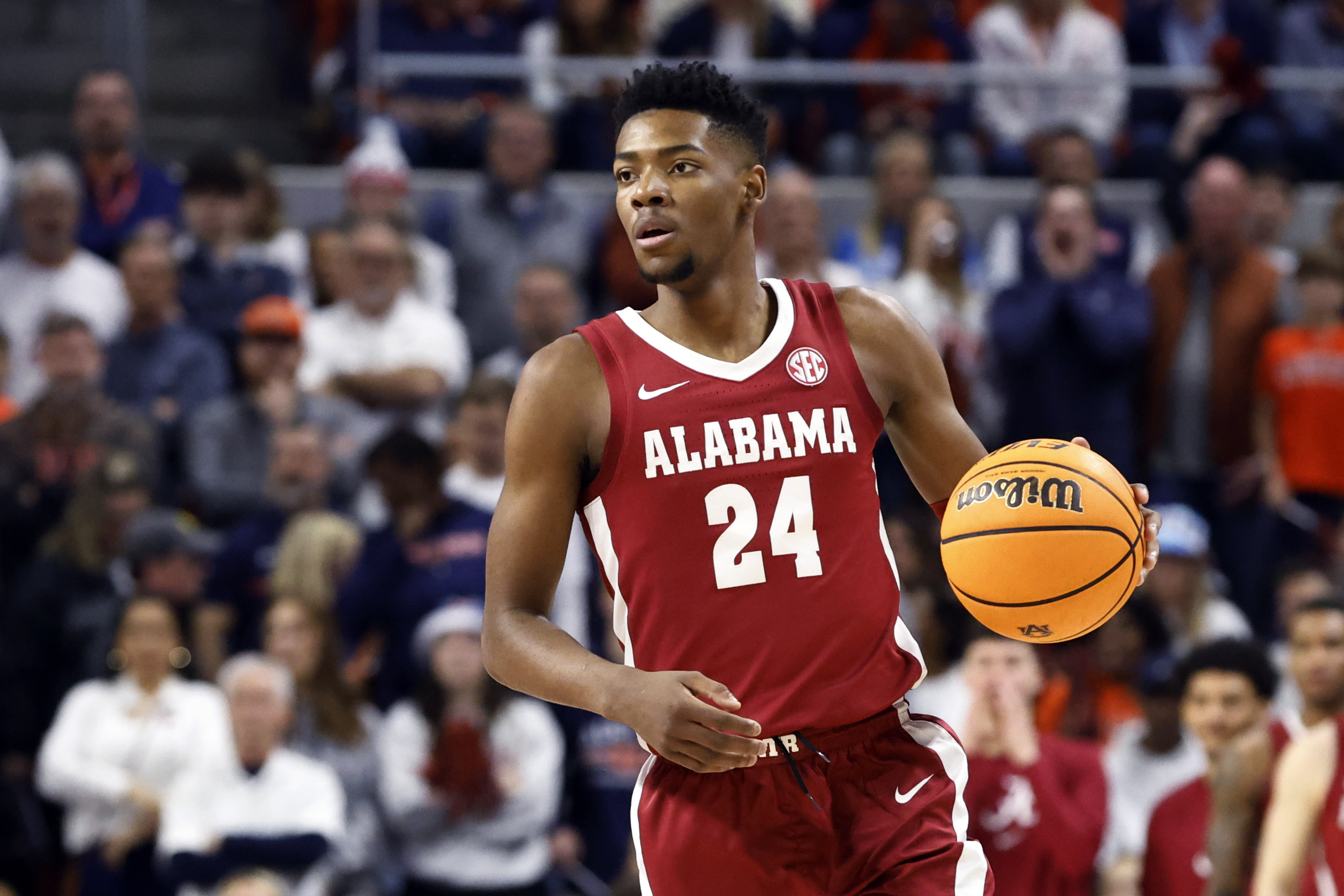 FILE - Alabama forward Brandon Miller brings the ball up during the first half of the team's NCAA college basketball game against Auburn on Feb. 11, 2023, in Auburn, Ala. Police say Miller brought a teammate the gun that was used in a fatal shooting near campus. Tuscaloosa Police investigator Brandon Culpepper testified during a preliminary hearing Tuesday, Feb. 21, that Miller brought Darius Miles’ gun to him on the night of the shooting after Miles texted him and asked him to do so.