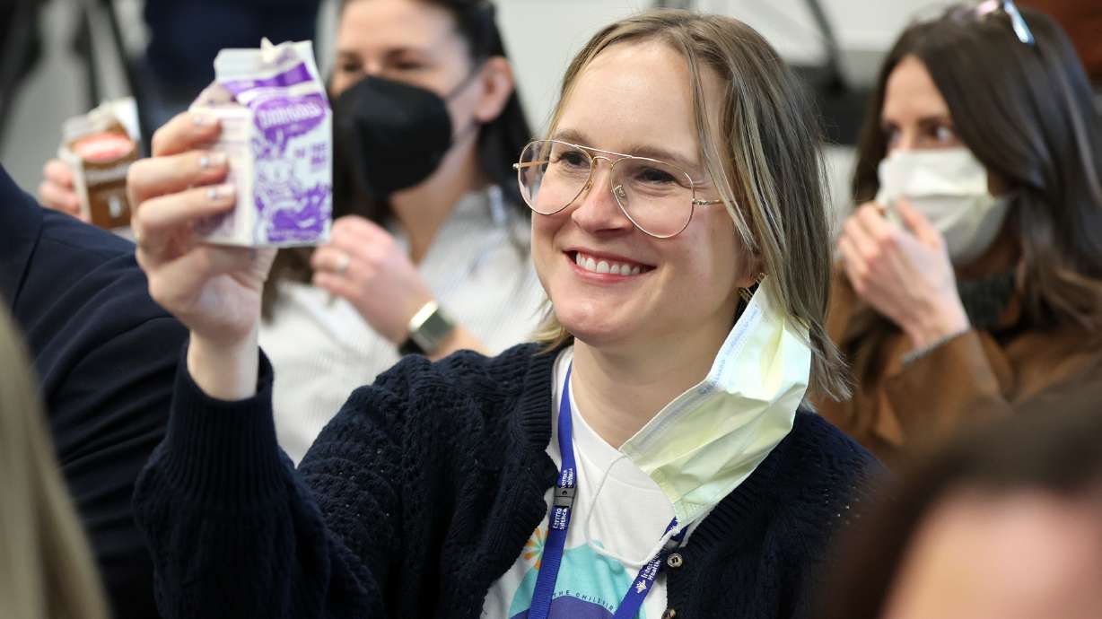 Stephanie Sokolowski, Intermountain Foundation director of corporate and foundation relations, and others raise cartons of milk in a toast to the new Primary Pantry at Primary Children’s Hospital Friday.