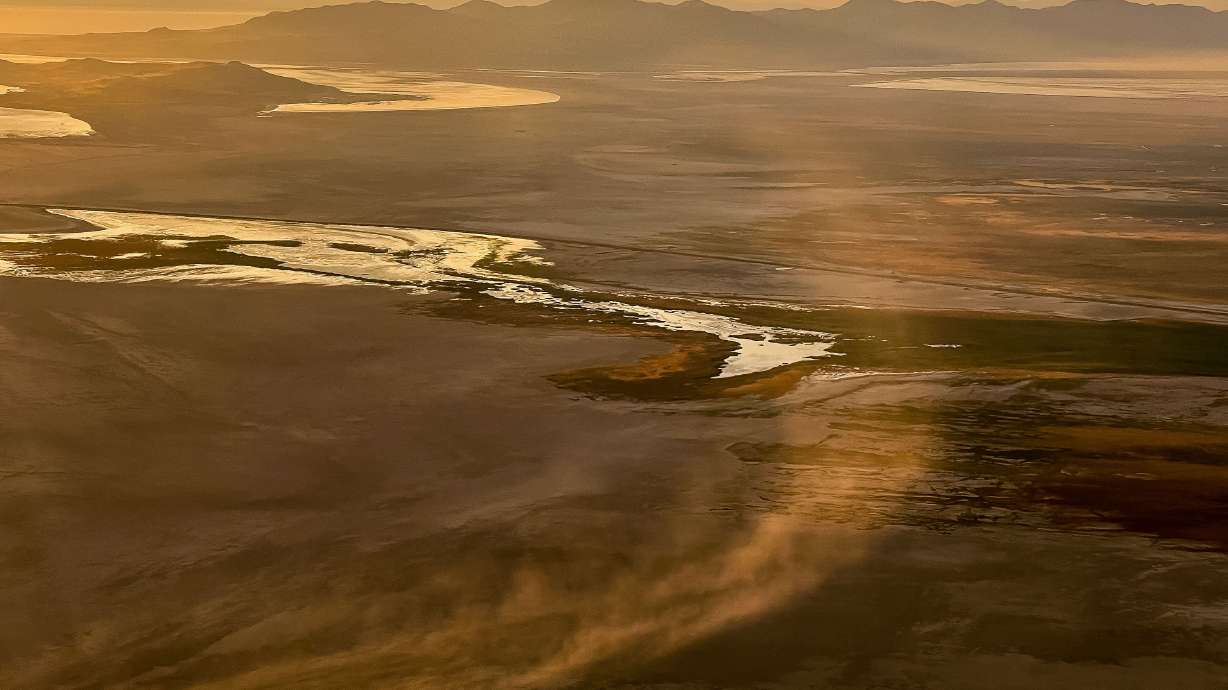 Dust blows across the dry lakebed of the Great Salt Lake near Salt Lake City on Aug. 12, 2022. A technical team will begin reviewing strategic locations for the placement of four new dust monitors.