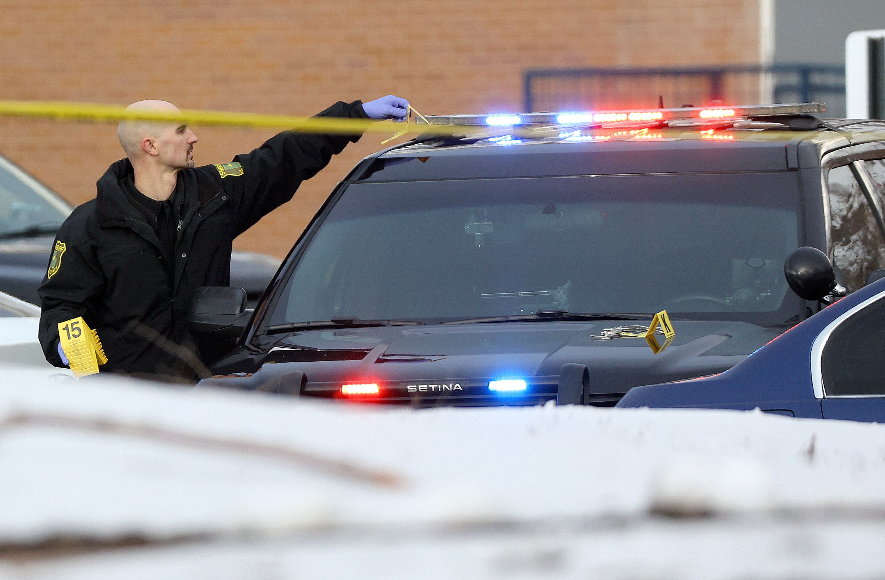 A Davis County sheriff employee works at the scene of a shooting in Farmington on March 1. The illegitimate license plate that resulted in the traffic shop that led to the shooting was a "sovereign" plate. 