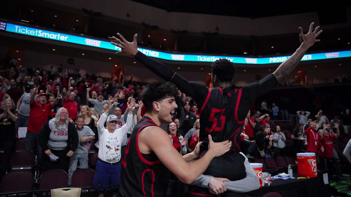 Tevian Jones (55) is hoisted up by his teammates after making the winning shot on a 4-point play to rally Southern Utah from 23-down in the second half and edge in-state rival Utah Valley in a WAC Tournament semifinal, Friday, March 10, 2023 at Orleans Arena in Las Vegas.