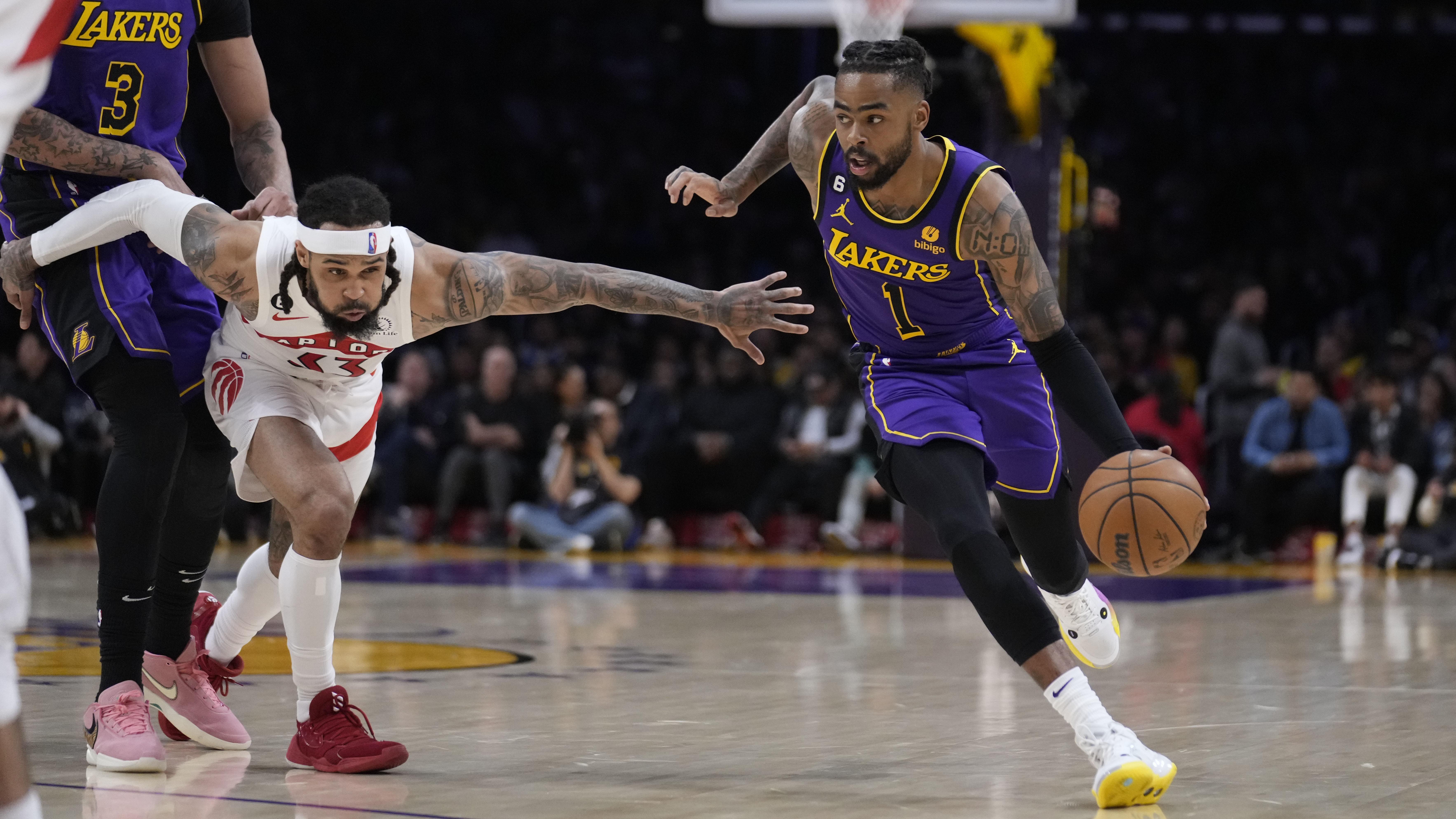 Los Angeles Lakers guard D'Angelo Russell (1) dribbles past Toronto Raptors guard Gary Trent Jr. during the first half of an NBA basketball game Friday, March 10, 2023, in Los Angeles. 