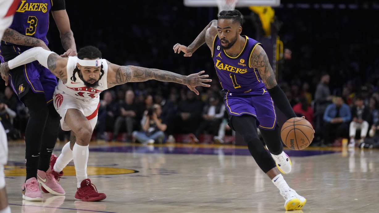 Los Angeles Lakers guard D'Angelo Russell (1) dribbles past Toronto Raptors guard Gary Trent Jr. during the first half of an NBA basketball game Friday, March 10, 2023, in Los Angeles.