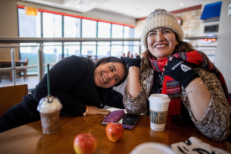 Zulema Diaz (R) and Maryangel Diaz, two Latino women who crossed from the U.S. border to Roxham Road in Quebec, order coffee at a hotel, in Niagara Falls, Ontario, Canada March 7.