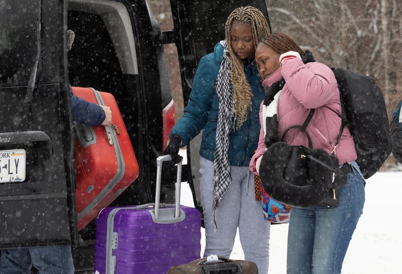 Two women, who state they are from the Republic of Congo, arrive by taxi to cross into Canada from the U.S. border on Roxham Road in Champlain, New York, U.S., Feb. 28.