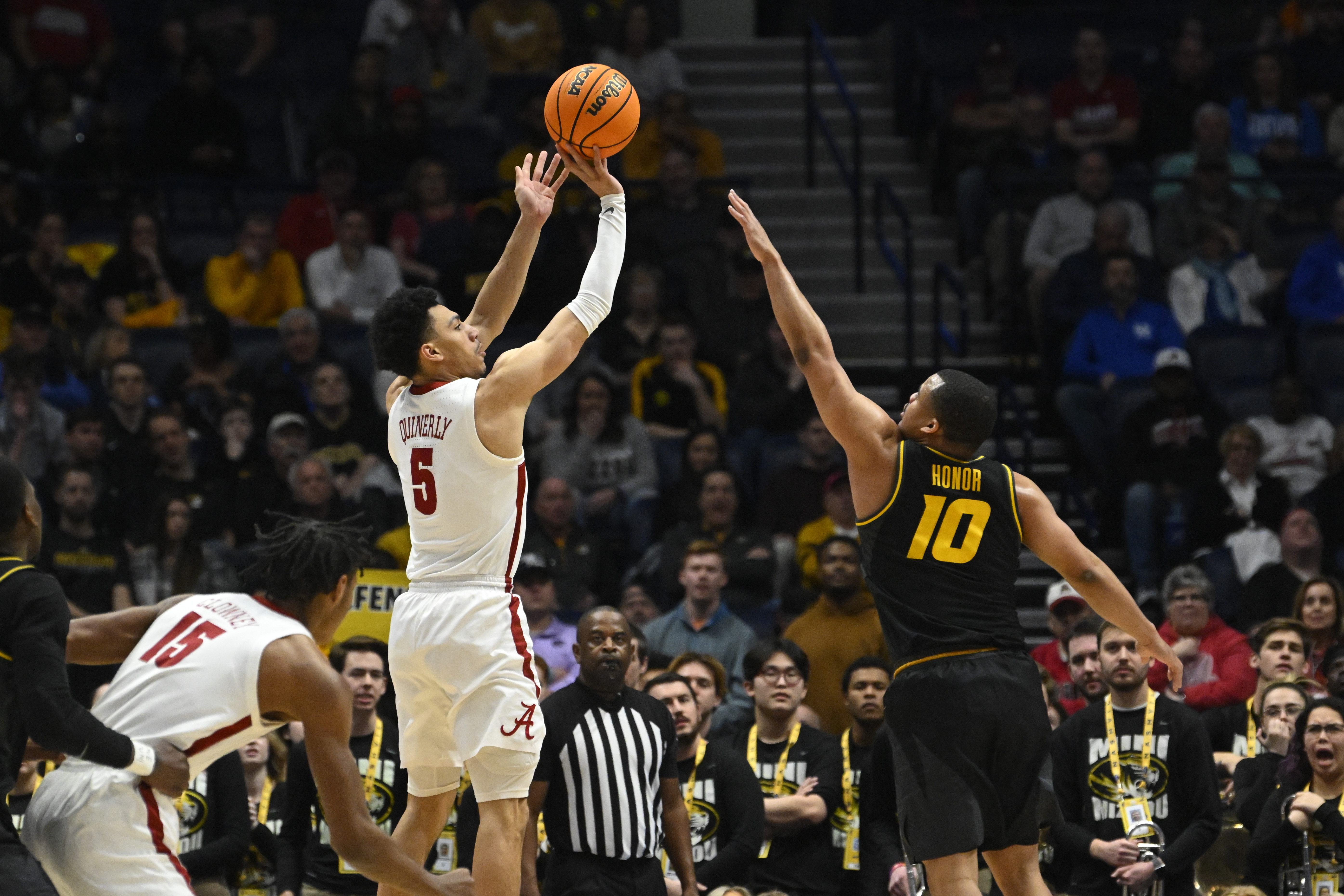 Alabama guard Jahvon Quinerly (5) shoots over Missouri guard Nick Honor during the first half of an NCAA college basketball game in the semifinals of the Southeastern Conference Tournament, Saturday, March 11, 2023, in Nashville, Tenn. 