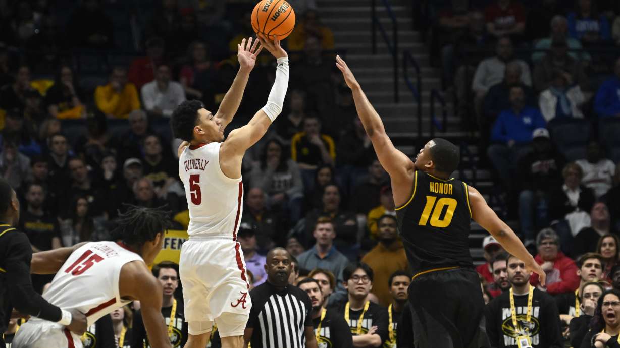Alabama guard Jahvon Quinerly (5) shoots over Missouri guard Nick Honor during the first half of an NCAA college basketball game in the semifinals of the Southeastern Conference Tournament, Saturday, March 11, 2023, in Nashville, Tenn.