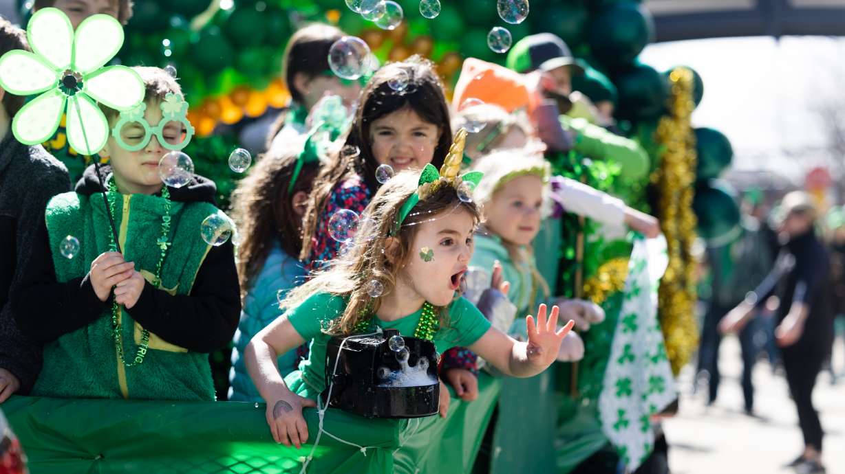 Children from the J.E. Cosgriff Memorial Catholic School and St. Ambrose Church blow bubbles during the St. Patrick’s Day Parade at The Gateway in Salt Lake City on Saturday.