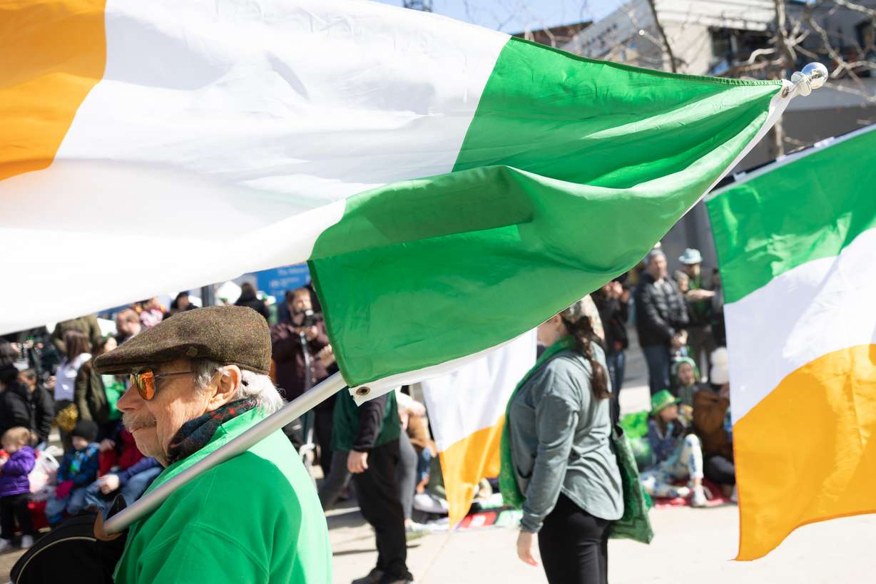 Gerald McDonough holds an Irish flag during the St. Patrick’s Day Parade at The Gateway in Salt Lake City on Saturday.