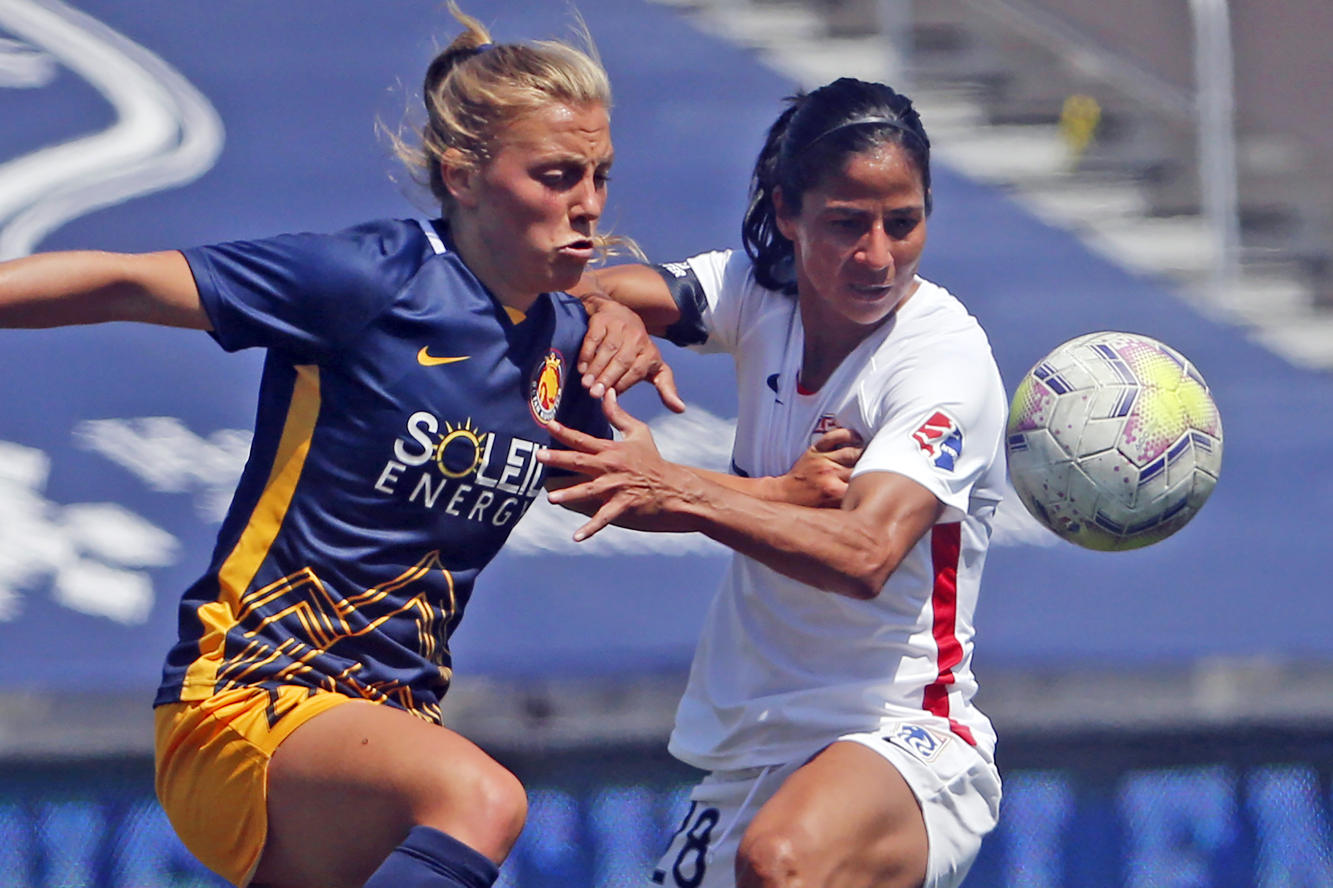 FILE - Utah Royals FC defender Madeline Nolf, left, battles with OL Reign midfielder Shirley Cruz, right, during the first half of an NWSL Challenge Cup soccer match at Zions Bank Stadium, Wednesday, July 8, 2020, in Herriman, Utah. The Royals are returning to Utah and the National Women's Soccer League. The NWSL and Major League Soccer's Real Salt Lake announced the second iteration of the Utah Royals on Saturday, March 11, 2023.. The Royals were part of the NWSL for three seasons from 2018 to 2020. 