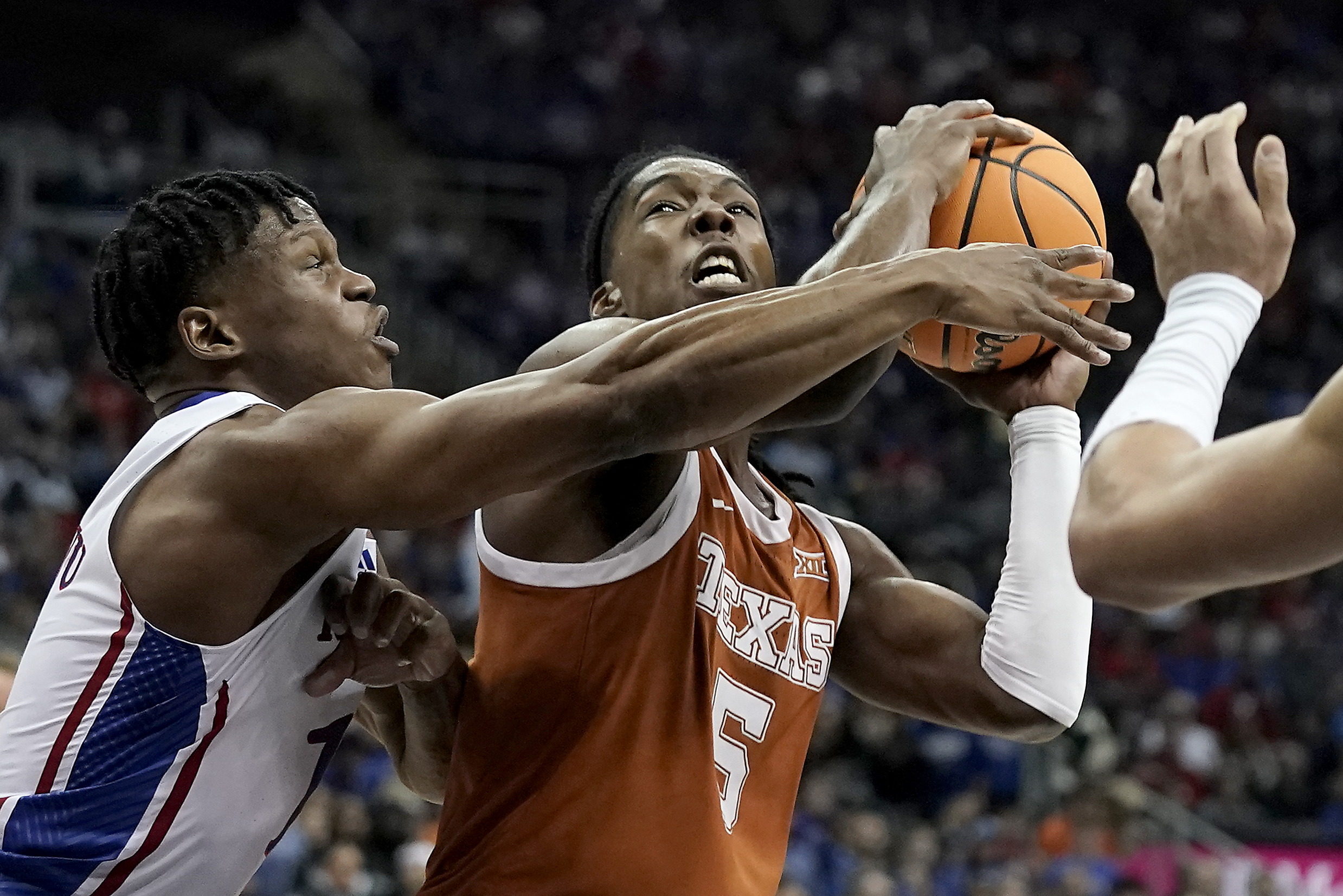 Texas guard Marcus Carr (5) shoots under pressure from Kansas guard Joseph Yesufu (1) during the first half of the NCAA college basketball championship game of the Big 12 Conference tournament Saturday, March 11, 2023, in Kansas City, Mo. 