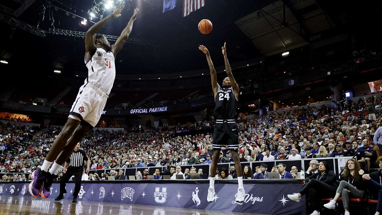 Utah State Aggies forward Zee Hamoda (24) shoots over San Diego State Aztecs forward Nathan Mensah (31) as Utah State and San Diego State play in the Mountain West Conference Basketball Tournament Championship at UNLV’s Thomas and Mack Center in Las Vegas on Saturday, March 11, 2023.