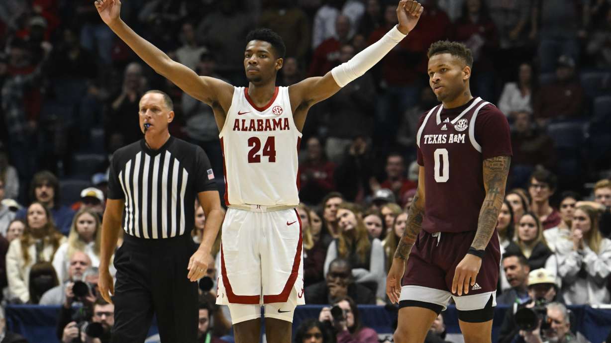 Alabama forward Brandon Miller (24) reacts as Texas A&M guard Dexter Dennis (0) looks on in the final minutes of an NCAA college basketball game in the finals of the Southeastern Conference Tournament, Sunday, March 12, 2023, in Nashville, Tenn.