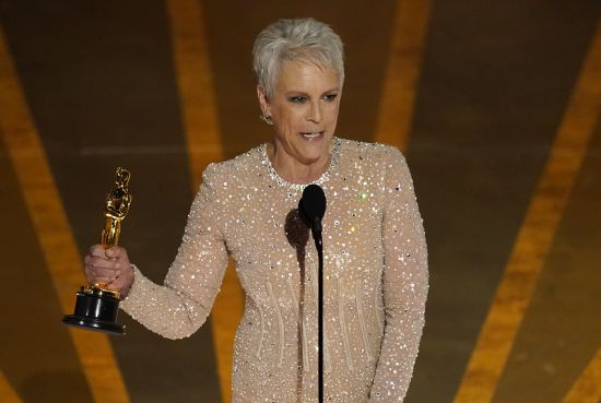 Jamie Lee Curtis accepts the award for best performance by an actress in a supporting role for "Everything Everywhere All at Once" at the Oscars on Sunday at the Dolby Theatre in Los Angeles.