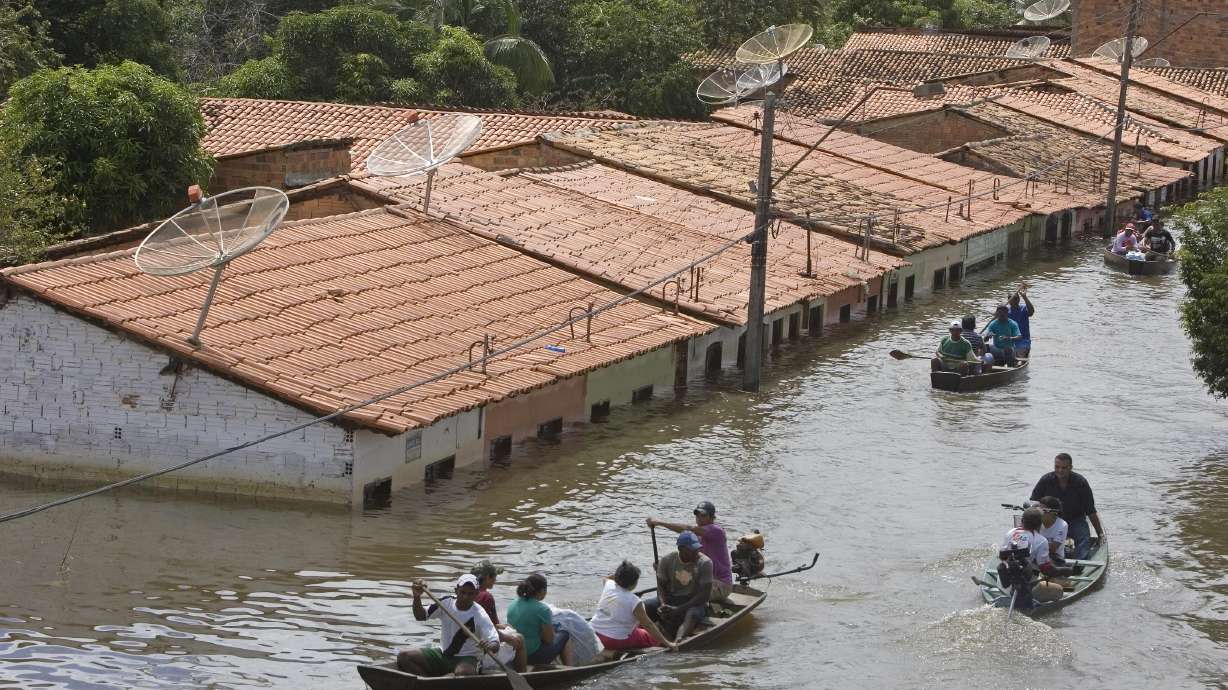 People travel by boat in a flooded street in Trizidela do Vale, Brazil, May 9, 2009. The intensity of extreme drought and rainfall has “sharply” increased over the past 20 years, according to a study published Monday.