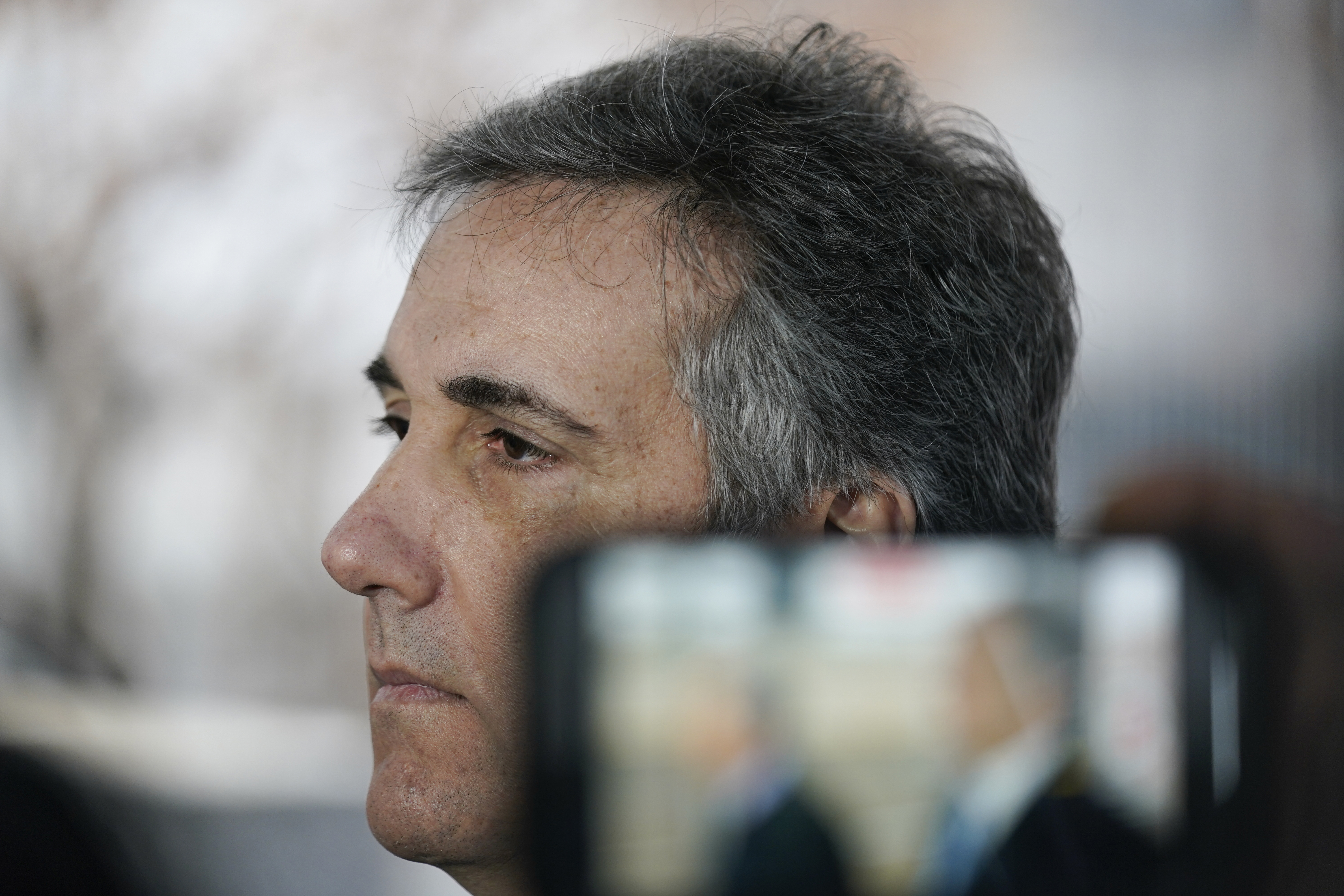 Michael Cohen talks to reporters as he arrives to testify before a grand jury in New York, Monday.