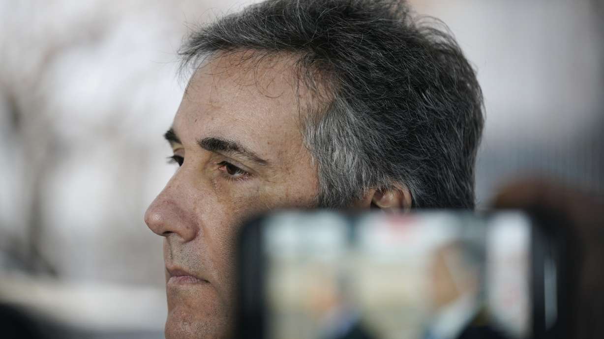 Michael Cohen talks to reporters as he arrives to testify before a grand jury in New York, Monday.
