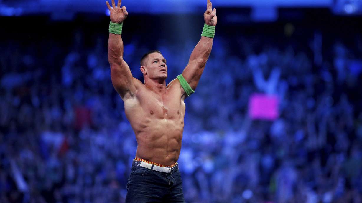 FILE- John Cena celebrates his win during Wrestlemania XXX in New Orleans on April 6, 2014. Cena has been revealed as this year's WWE 2K23 video game cover star. The wrestling game is out Tuesday, March 14, 2023.