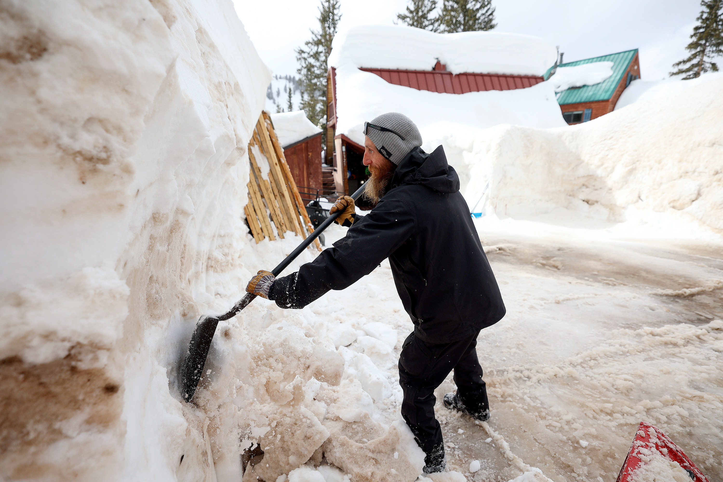 Wesley Seybold tries to reclaim his driveway by shoveling and snowblowing in Brighton on March 13. Snow or impacts from a record snowpack led to three of the top 10 most-read KSL.com stories in 2023.