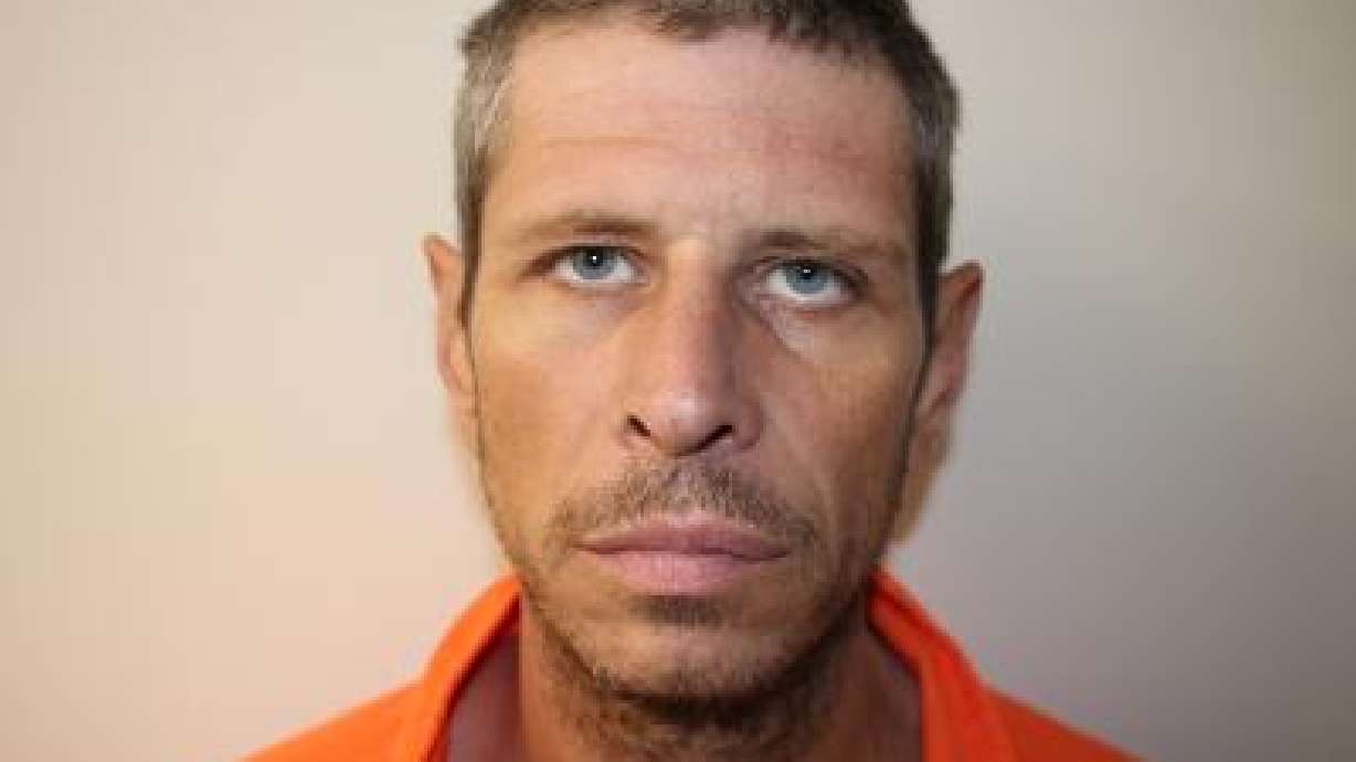 Cleo Kyle Cheney, 42, was charged Monday in 6th District Court with manslaughter, a second-degree felony, in the death of a fellow prison inmate in August.