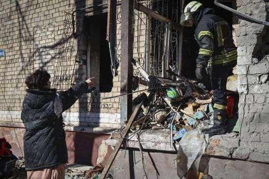Ukrainian Emergency Service rescuers work on a building damaged by shelling in Kramatorsk, Donetsk region, Ukraine, Tuesday. One person has been killed, according to local authorities.