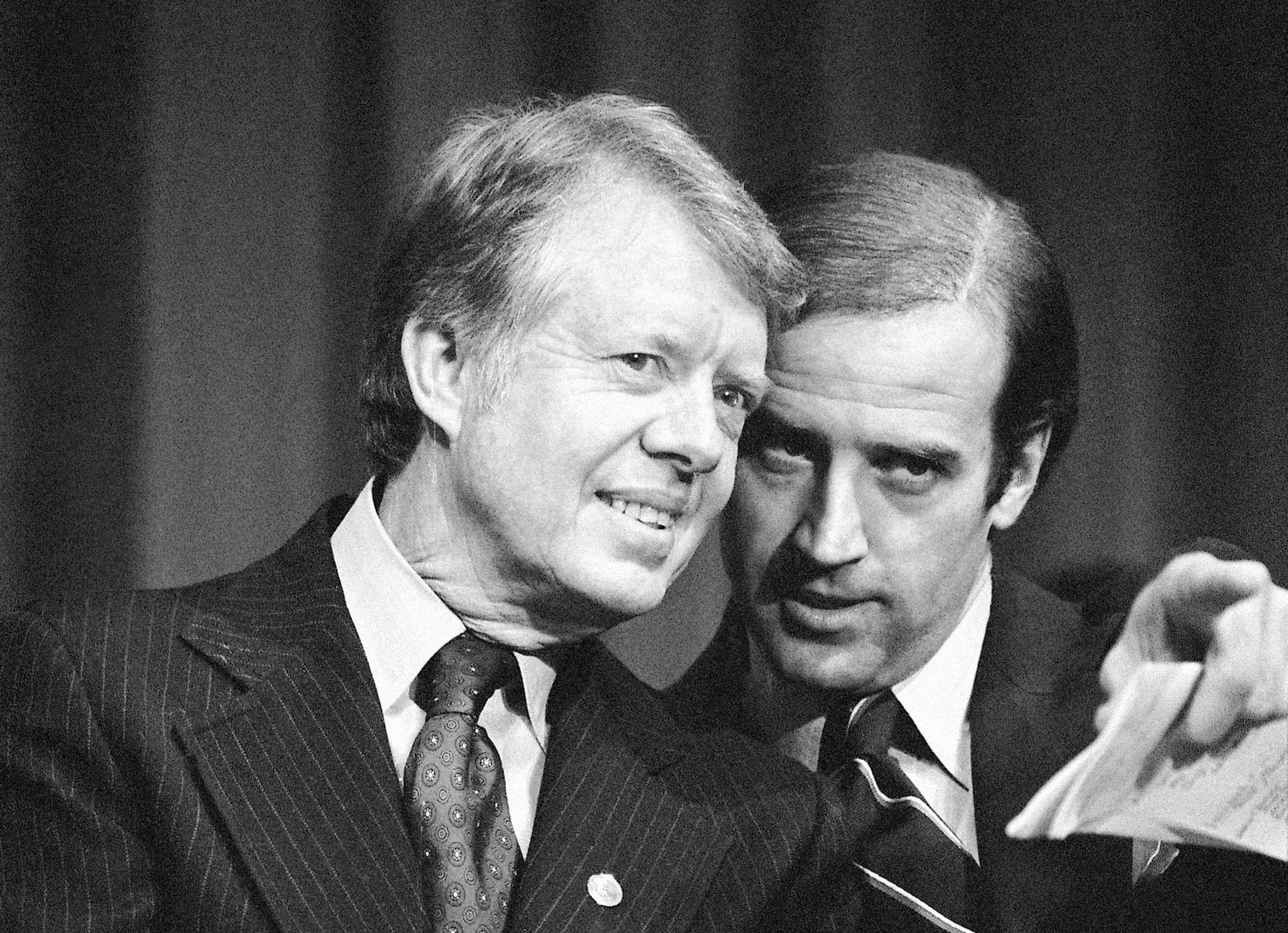 President Jimmy Carter listens to then-Sen. Joe Biden at Padua Academy in Wilmington, Del., Feb. 20, 1978. Biden says he plans to deliver the eulogy at the funeral of Carter, who remains under hospice care at his home in south Georgia. 