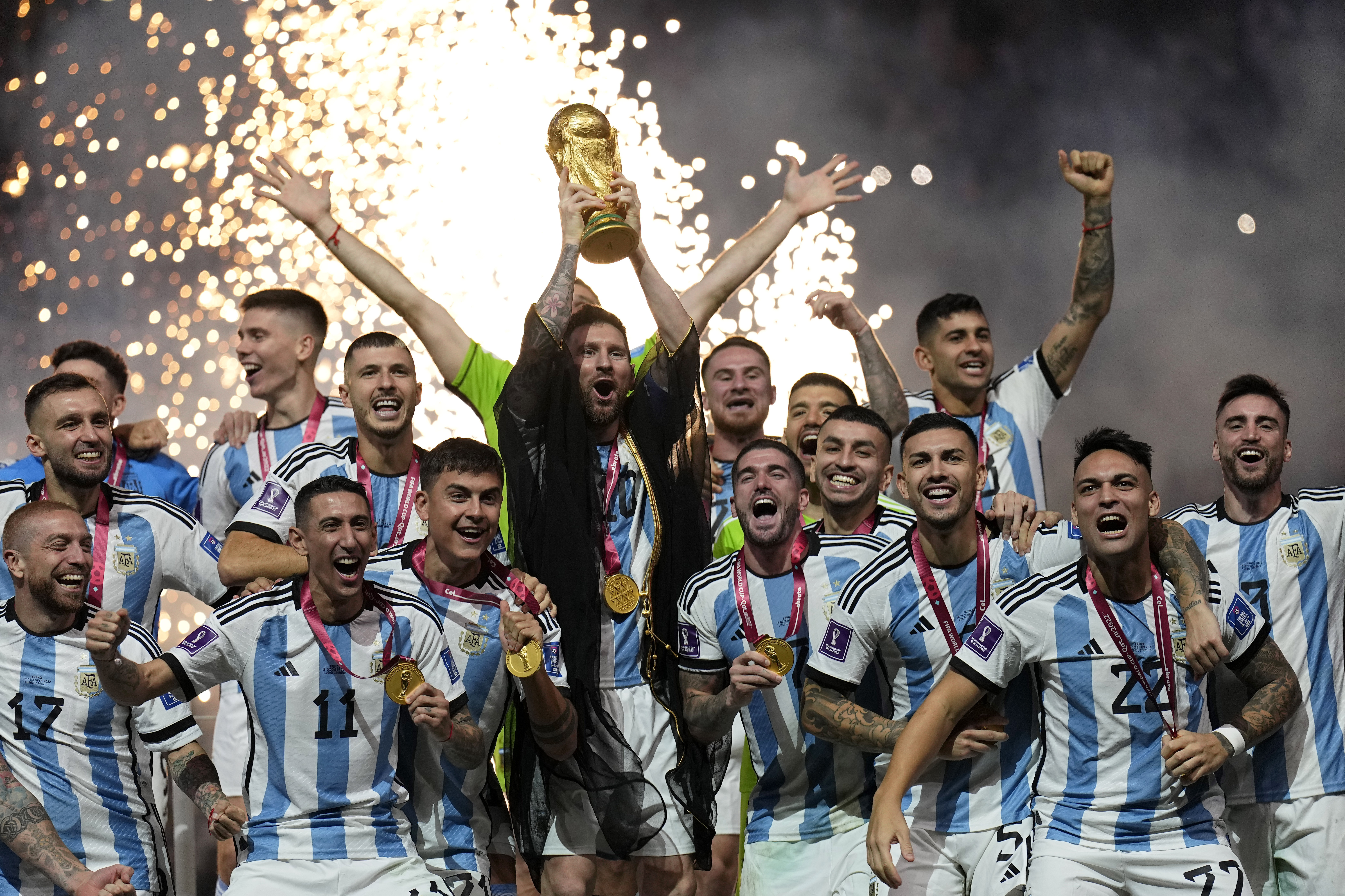 FILE - Argentina's Lionel Messi lifts the trophy after winning the World Cup final soccer match between Argentina and France at the Lusail Stadium in Lusail, Qatar, Sunday, Dec. 18, 2022. The World Cup group stage format for 2026 was changed to 12 groups of four teams from 16 groups of three teams by FIFA’s Council on Tuesday, March 14, 2023. 