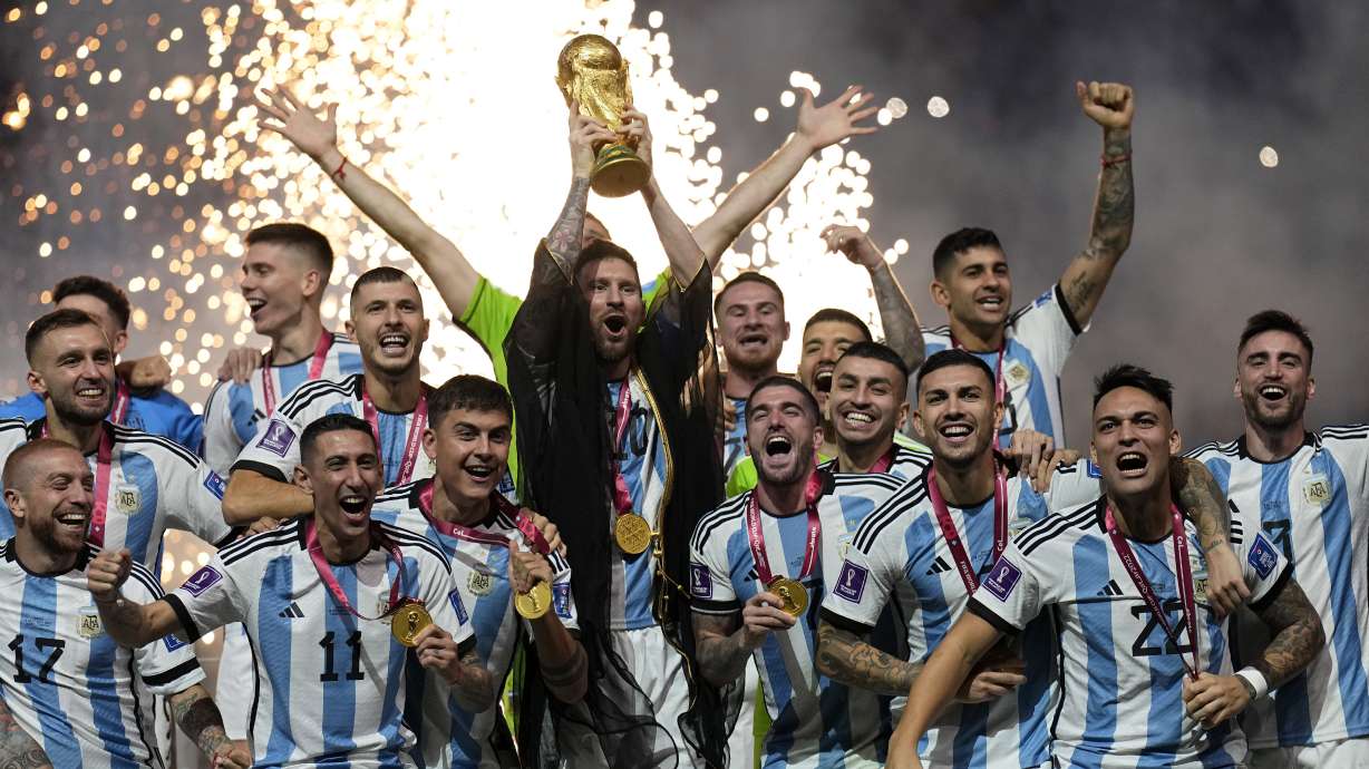 FILE - Argentina's Lionel Messi lifts the trophy after winning the World Cup final soccer match between Argentina and France at the Lusail Stadium in Lusail, Qatar, Sunday, Dec. 18, 2022. The World Cup group stage format for 2026 was changed to 12 groups of four teams from 16 groups of three teams by FIFA’s Council on Tuesday, March 14, 2023.