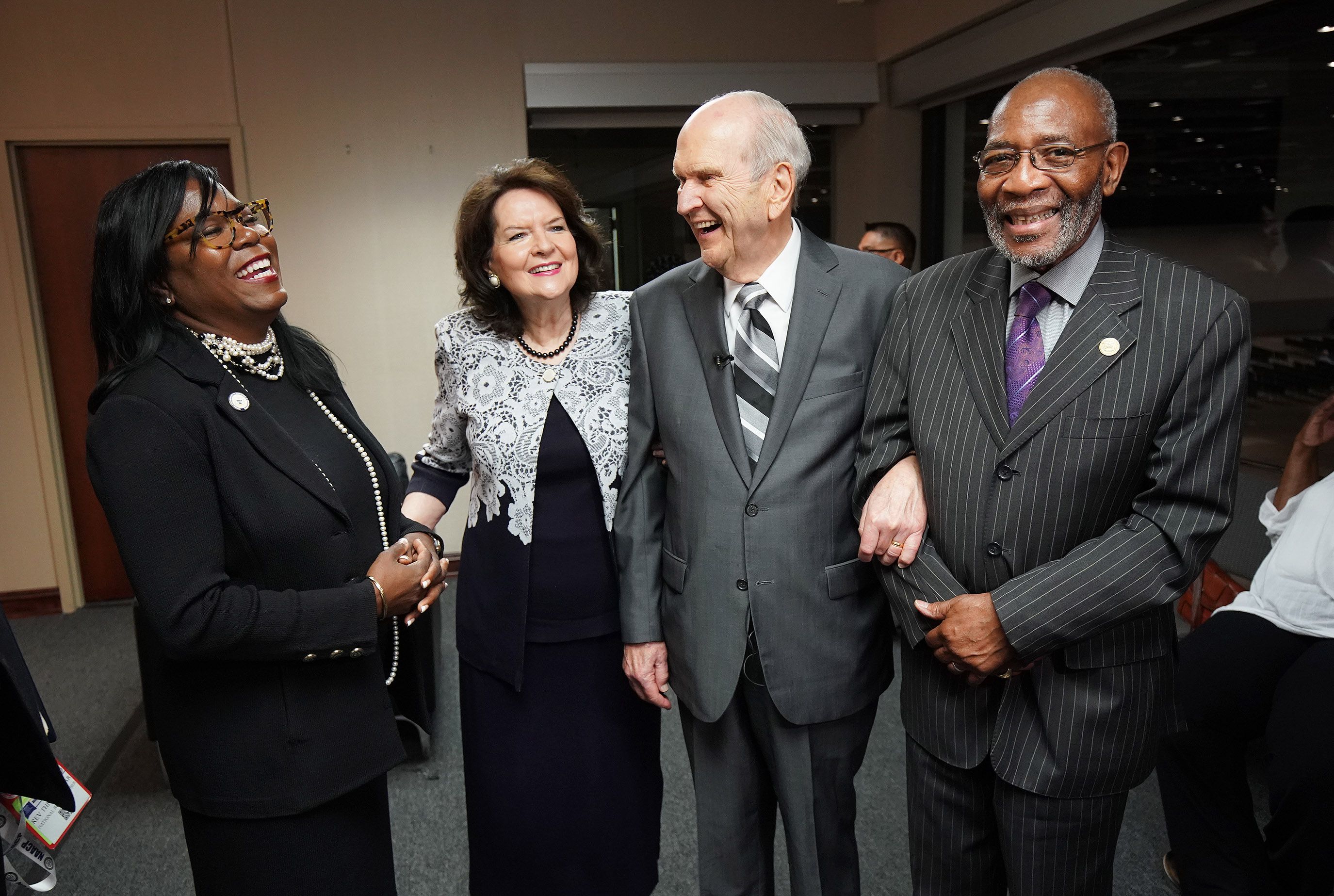 President Russell M. Nelson of The Church of Jesus Christ of Latter-day Saints and his wife, Sister Wendy Nelson, share a laugh with the Rev. Theresa Dear, left, and the Rev. Amos Brown, right, at the 110th annual national convention for the National Association for the Advancement of Colored People in Detroit, Michigan, on July 21, 2019.