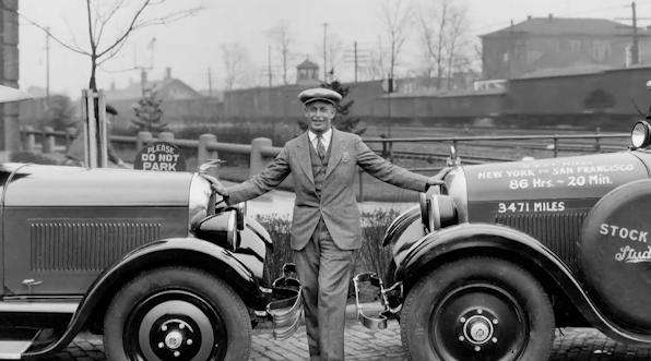 Ab Jenkins stands in between two Studebakers in this undated photo.