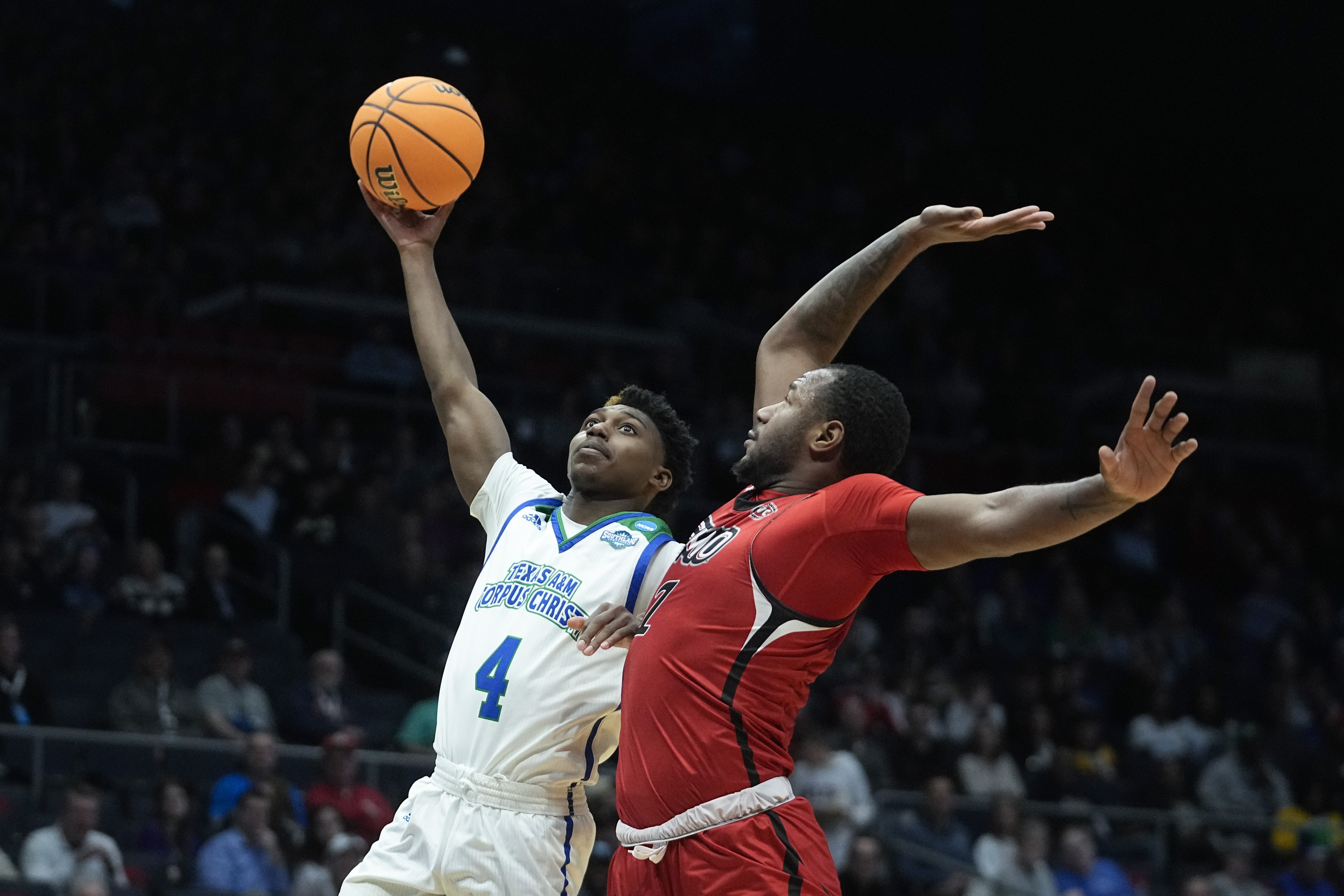 Texas A&M Corpus Christi's Jalen Jackson (4) shoots against Southeast Missouri State's Phillip Russell (1) during the first half of a First Four college basketball game in the NCAA men's basketball tournament, Tuesday, March 14, 2023, in Dayton, Ohio. 