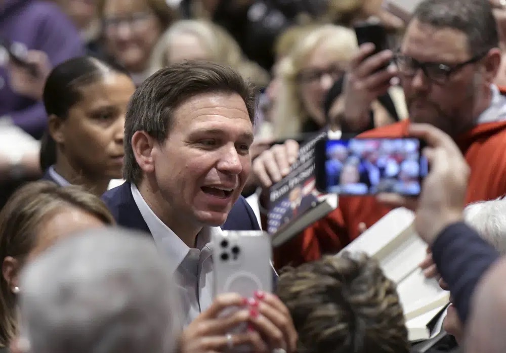 Florida Gov. Ron DeSantis greets people in the crowd during an event, March 10 in Davenport, Iowa.