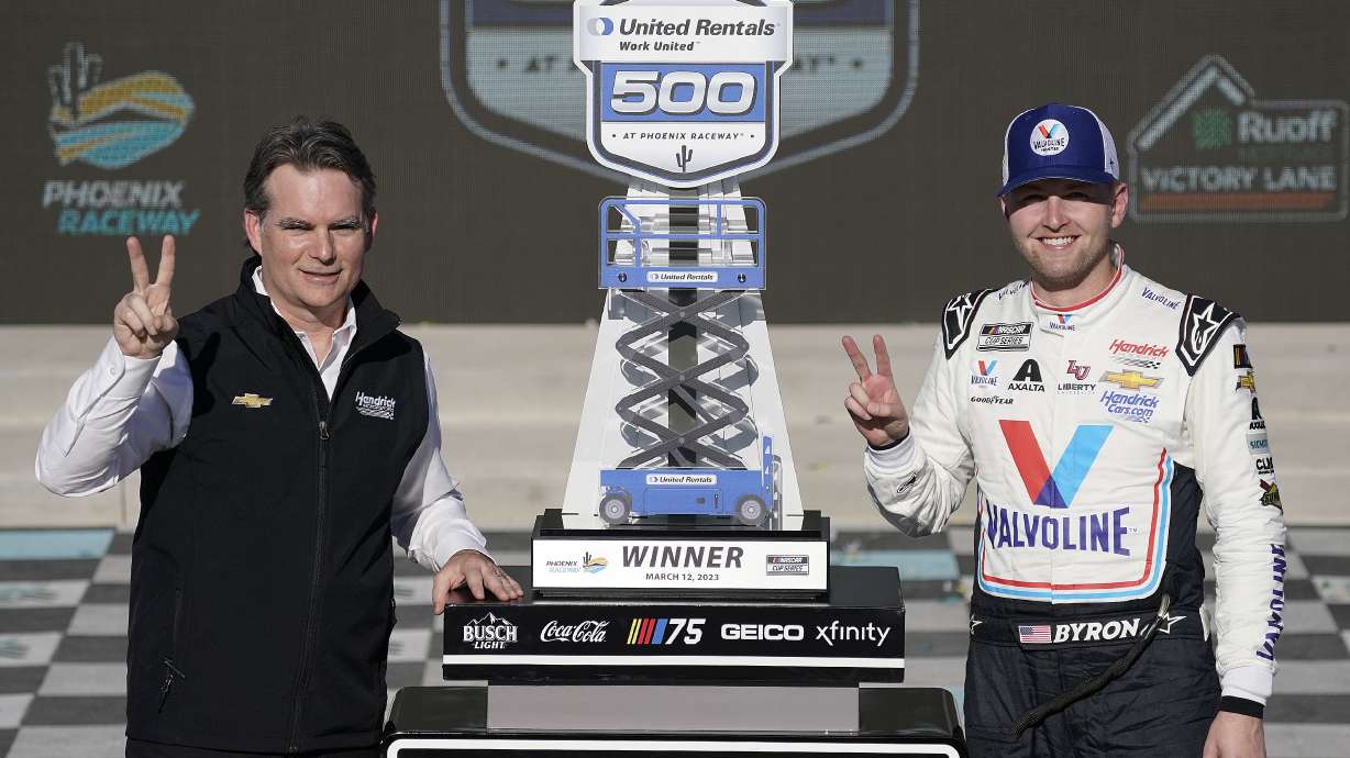 NASCAR legend Jeff Gordon, left, and William Byron, pose with Byron's trophy after winning the NASCAR Cup Series auto race at Phoenix Raceway, Sunday, March 12, 2023, in Avondale, Ariz.