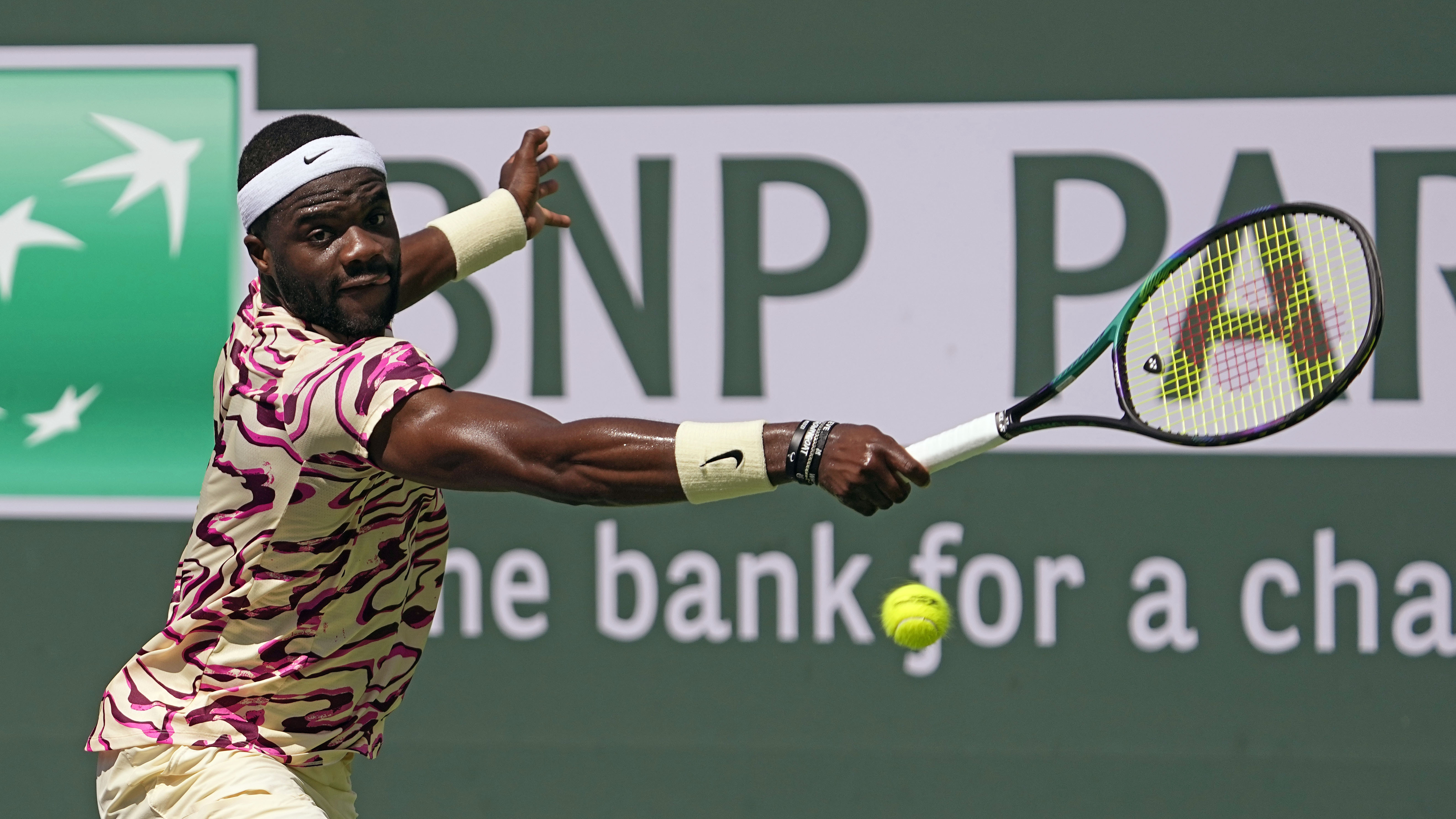 Frances Tiafoe, of the United States, returns a shot to Cameron Norrie, of Britain, at the BNP Paribas Open tennis tournament Wednesday, March 15, 2023, in Indian Wells, Calif.