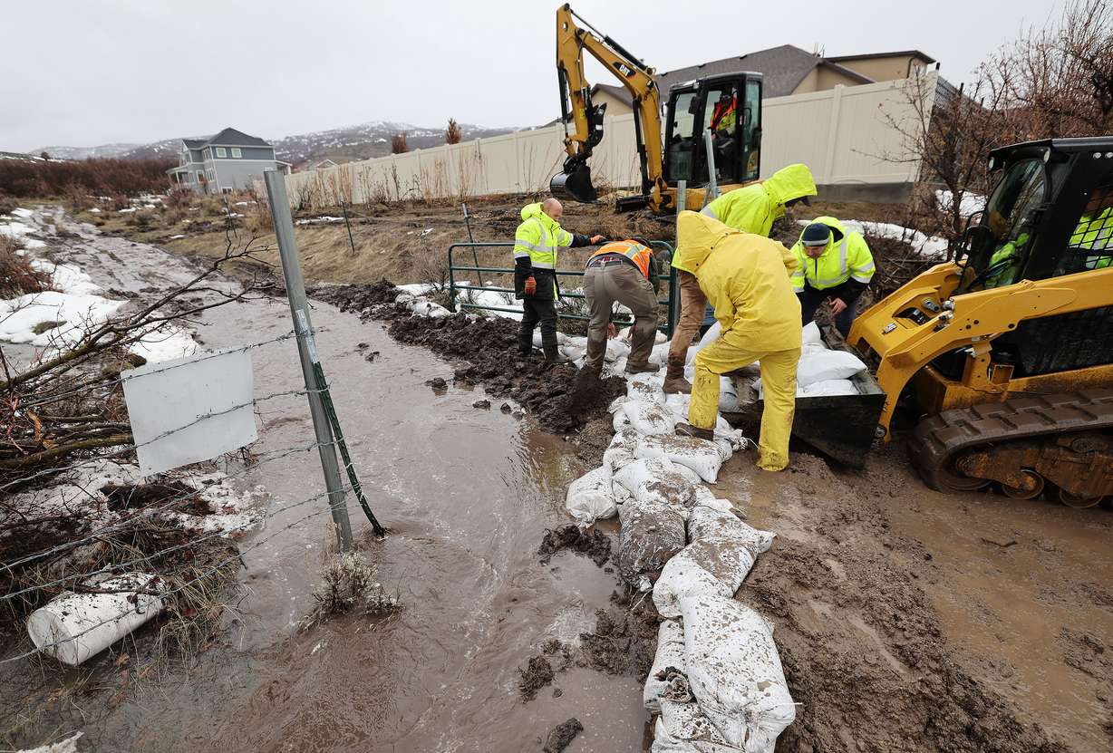 City employees fill sand bags due to flooding in Highland on Wednesday.