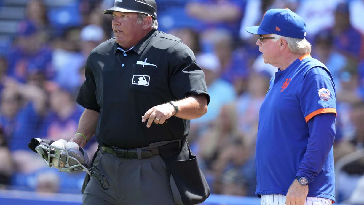 New York Mets manager Buck Showalter, right, talks with home plate umpire Hunter Wendelstedt during the third inning of a spring training baseball game against the New York Mets, Tuesday, March 14, 2023, in Port St. Lucie, Fla.