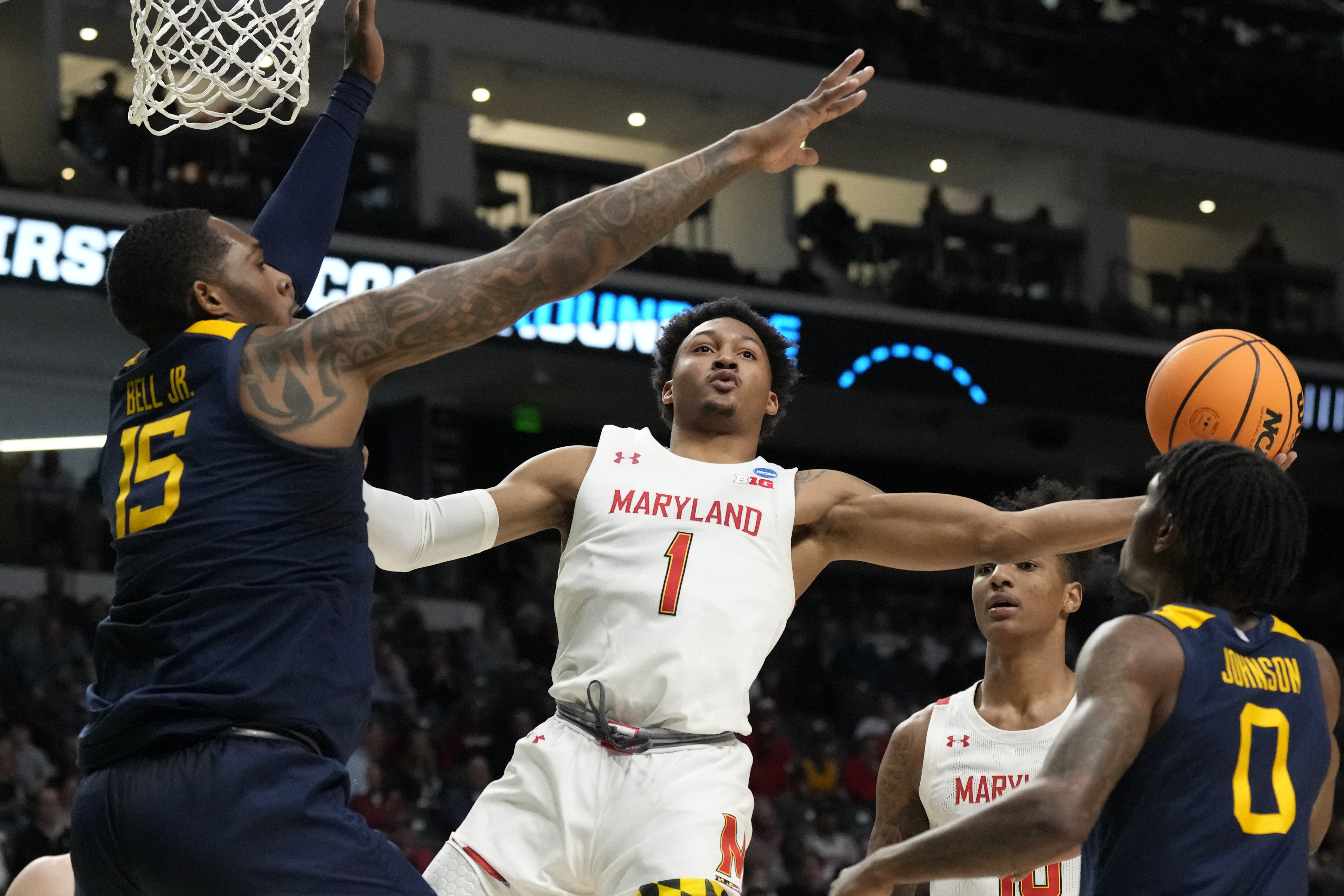 Maryland guard Jahmir Young (1) attempts a layup past West Virginia forward Jimmy Bell Jr. (15) in the first half of a first-round college basketball game in the NCAA Tournament in Birmingham, Ala., Thursday, March 16, 2023. 