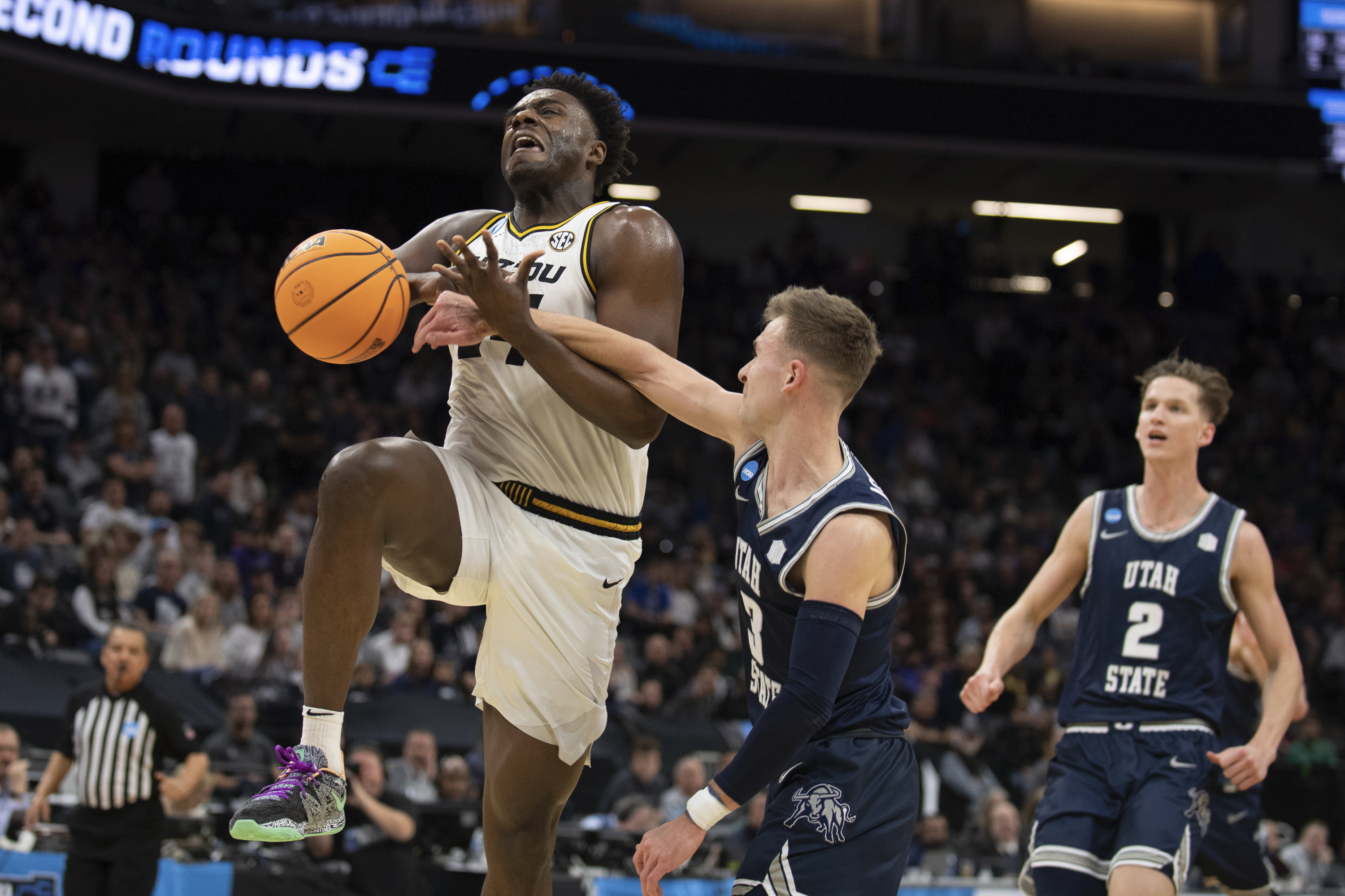 Missouri guard Kobe Brown (24) is fouled by Utah State guard Steven Ashworth (3) during the second half of a first-round college basketball game in the NCAA Tournament in Sacramento, Calif., Thursday, March 16, 2023. 