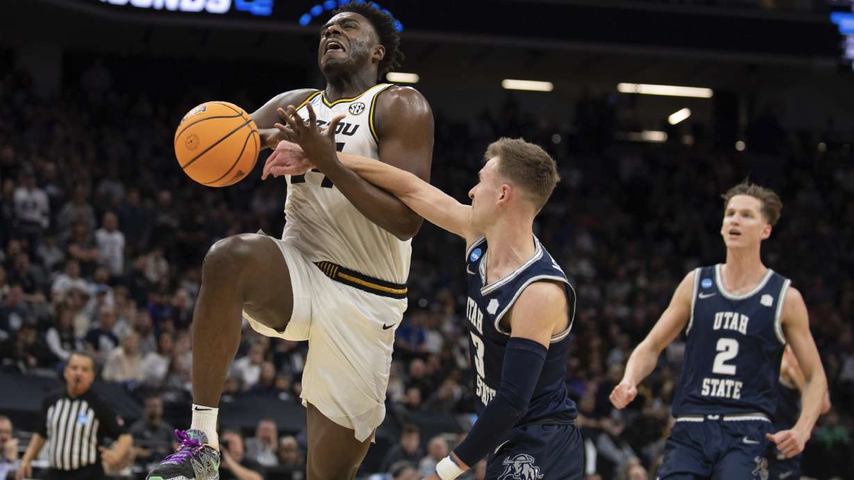 Missouri guard Kobe Brown (24) is fouled by Utah State guard Steven Ashworth (3) during the second half of a first-round college basketball game in the NCAA Tournament in Sacramento, Calif., Thursday, March 16, 2023.