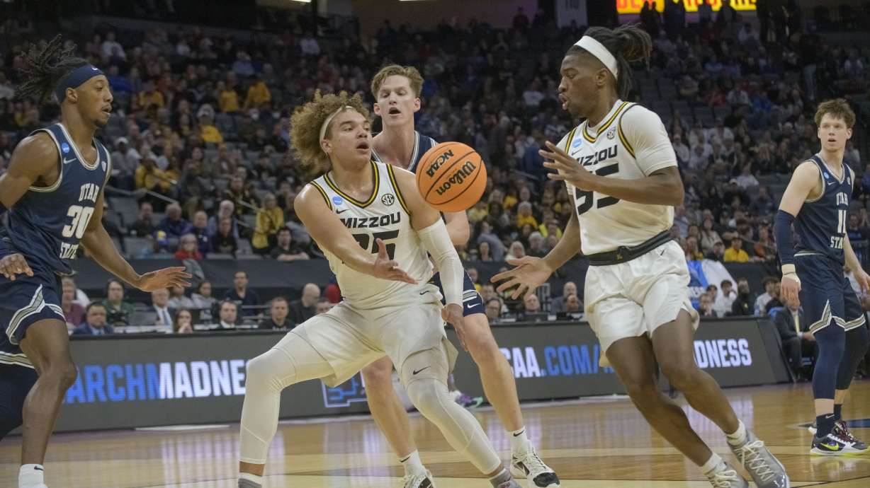 Missouri forward Noah Carter passes the ball to guard Sean East II during the first half of a first-round college basketball game against Utah State in the NCAA Tournament in Sacramento, Calif., Thursday, March 16, 2023.