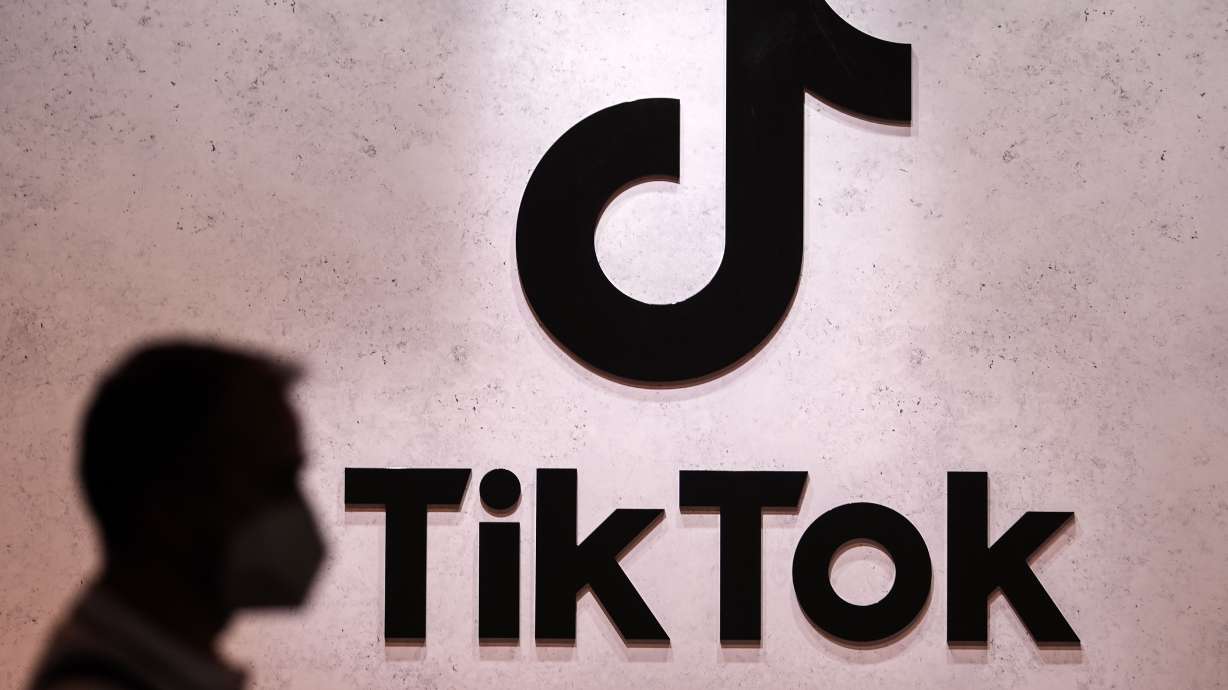 A visitor passes the TikTok exhibition stands at the Gamescom computer gaming fair in Cologne, Germany on Aug. 25, 2022. The U.K. has banned TikTok on government devices.