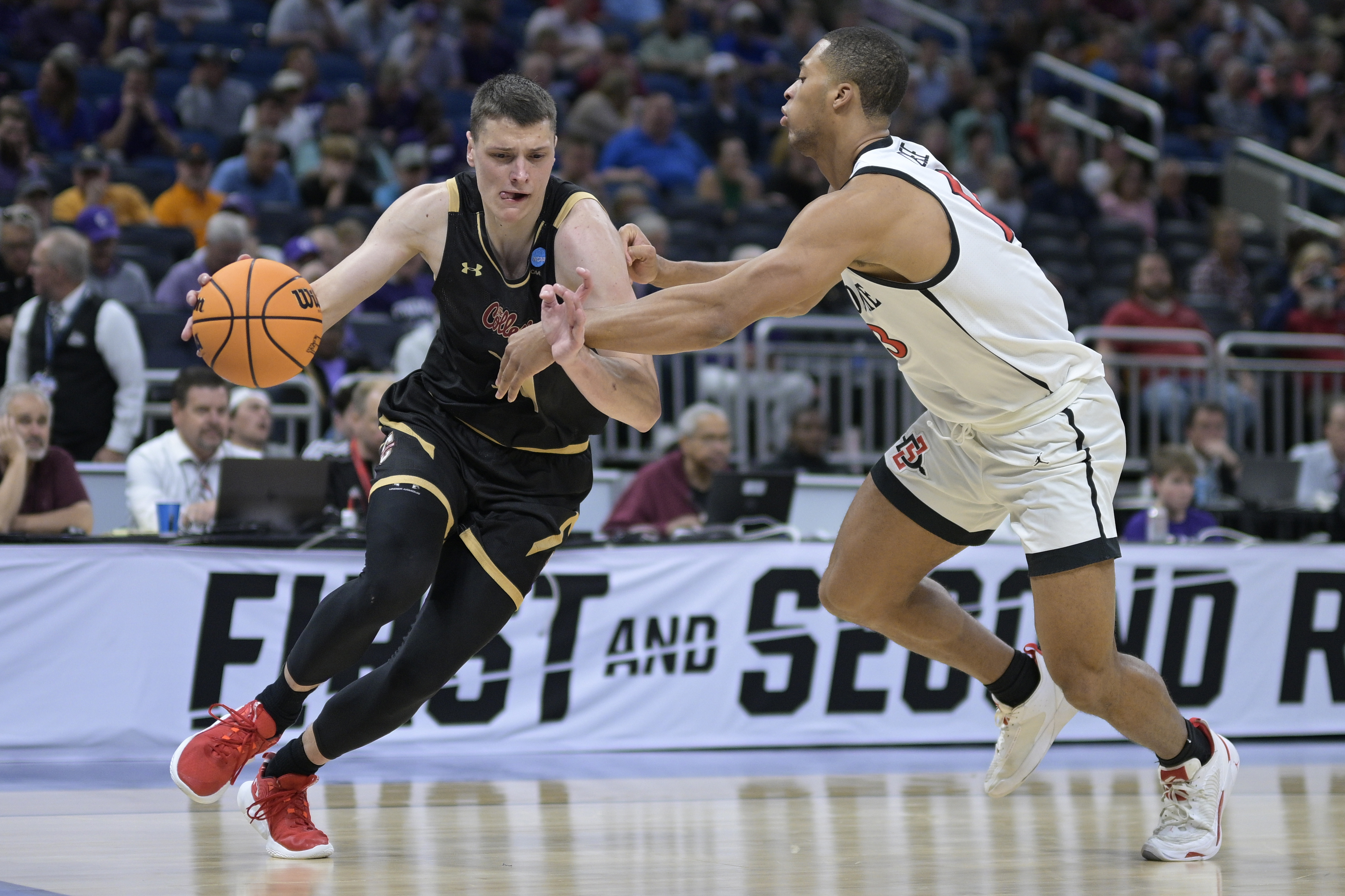 Charleston forward Ante Brzovic, left, drives as San Diego State forward Jaedon LeDee (13) defends during the first half of a first-round college basketball game in the NCAA Tournament, Thursday, March 16, 2023, in Orlando, Fla.