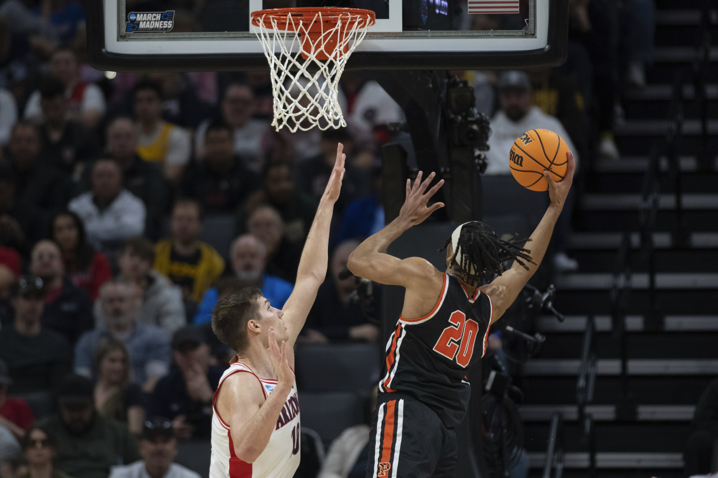 Princeton forward Tosan Evbuomwan (20) scores a basket in front of Arizona forward Azuolas Tubelis (10) during the first half of a first-round college basketball game in the NCAA Tournament in Sacramento, Calif., Thursday, March 16, 2023. 