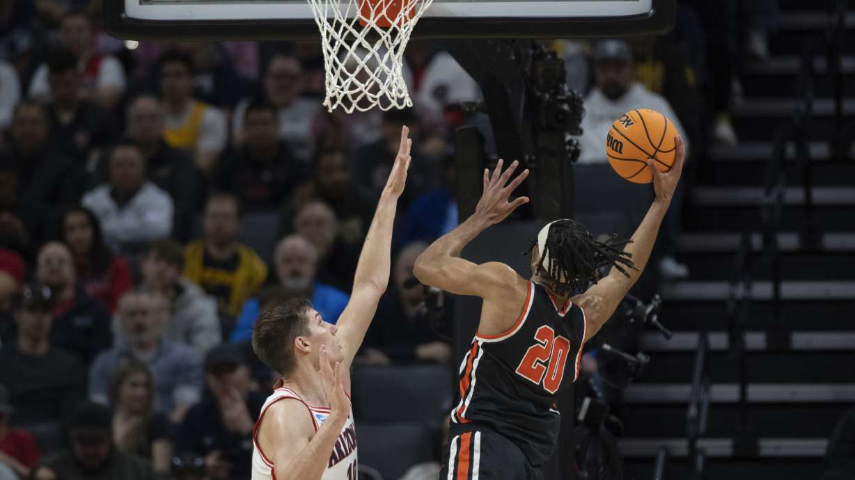 Princeton forward Tosan Evbuomwan (20) scores a basket in front of Arizona forward Azuolas Tubelis (10) during the first half of a first-round college basketball game in the NCAA Tournament in Sacramento, Calif., Thursday, March 16, 2023.
