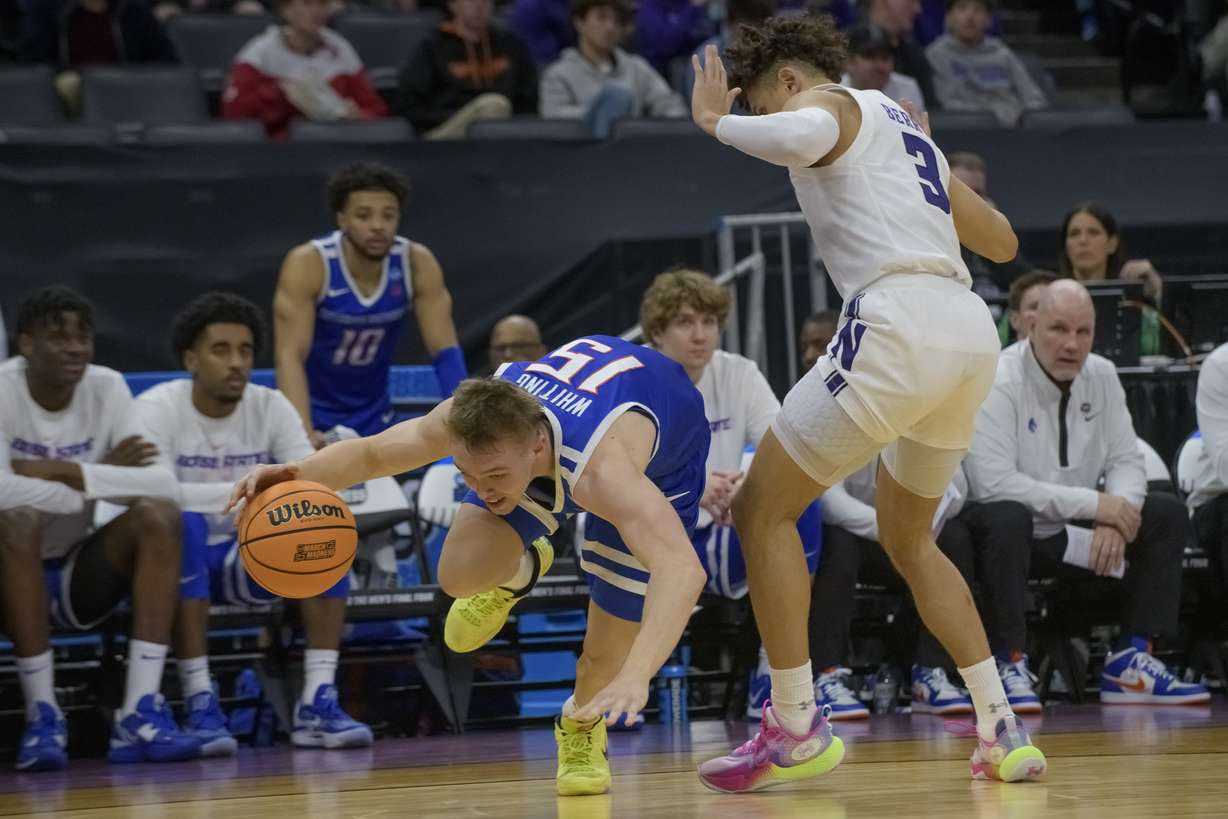 Boise State guard Jace Whiting (15) stumbles over Northwestern guard Ty Berry (3) during the second half of a first-round college basketball game in the NCAA Tournament in Sacramento, Calif., Thursday, March 16, 2023. Northwestern won 75-67.