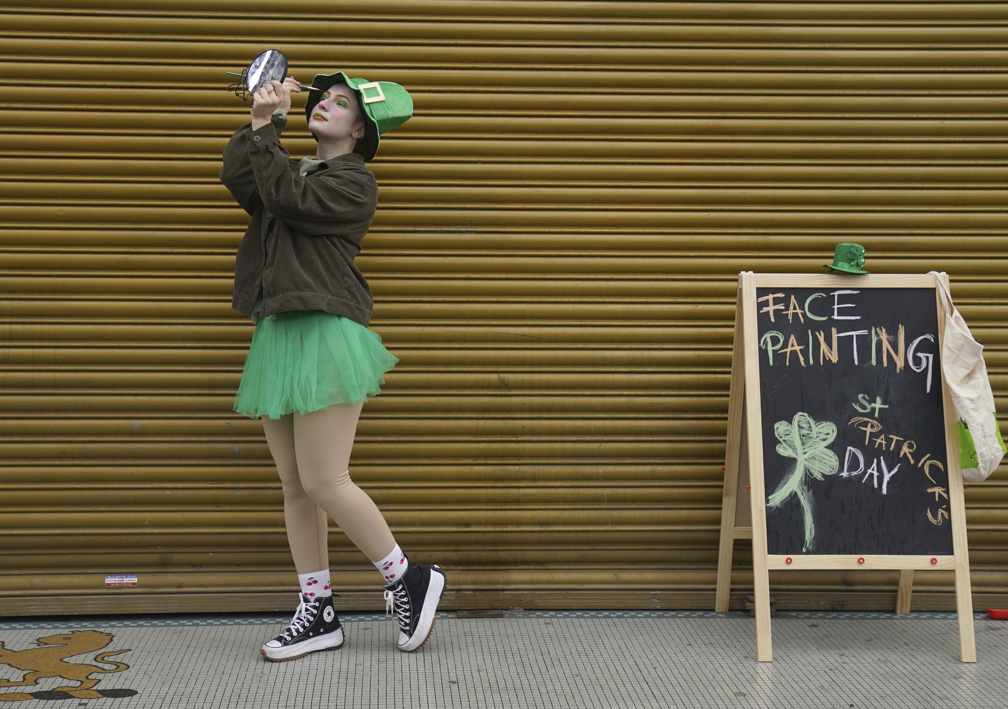 A face painter applies eye shadow, ahead of the St Patrick's Day Parade in Dublin, Friday. St. Patrick's Day is full of festivities across the U.S.