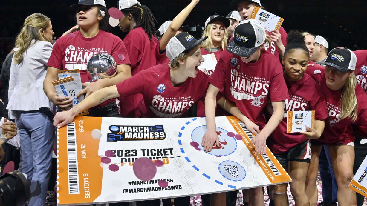 Washington State celebrates by "punching their ticket" after the team defeated UCLA in an NCAA college basketball game in the finals of the Pac-12 women's tournament, Sunday, March 5, 2023, in Las Vegas.
