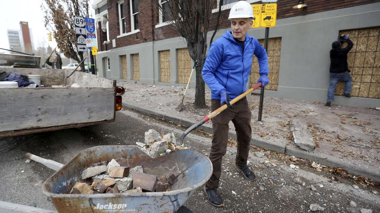 Paul Foster, a waiter at Caffe Molise, shovels debris in Salt Lake City after a 5.7-magnitude earthquake on March 18, 2020. Utah Geological Survey officials say it is feasible for Utah to offer early earthquake detection in the future.