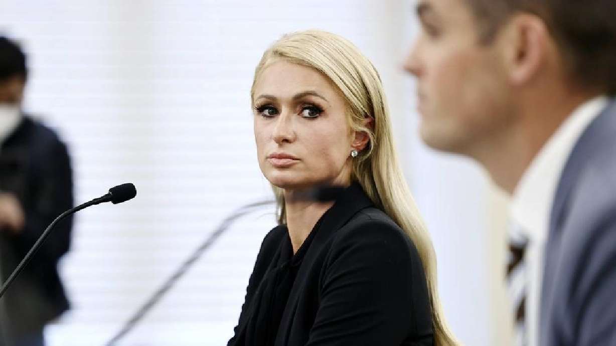 Paris Hilton looks over at Sen. Mike McKell, R-Spanish Fork, as they testify about SB127 at the Capitol in Salt Lake City on Feb. 8, 2021. In her new book, she recalls the abuse at the hands of the former staff at Provo Canyon School.